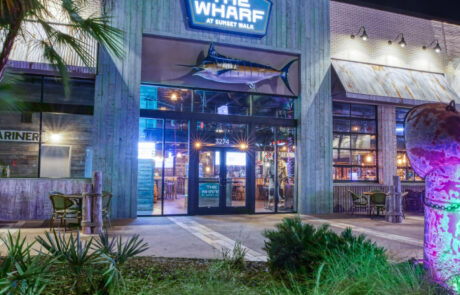 The Wharf at Sunset Walk entrance at night with lights