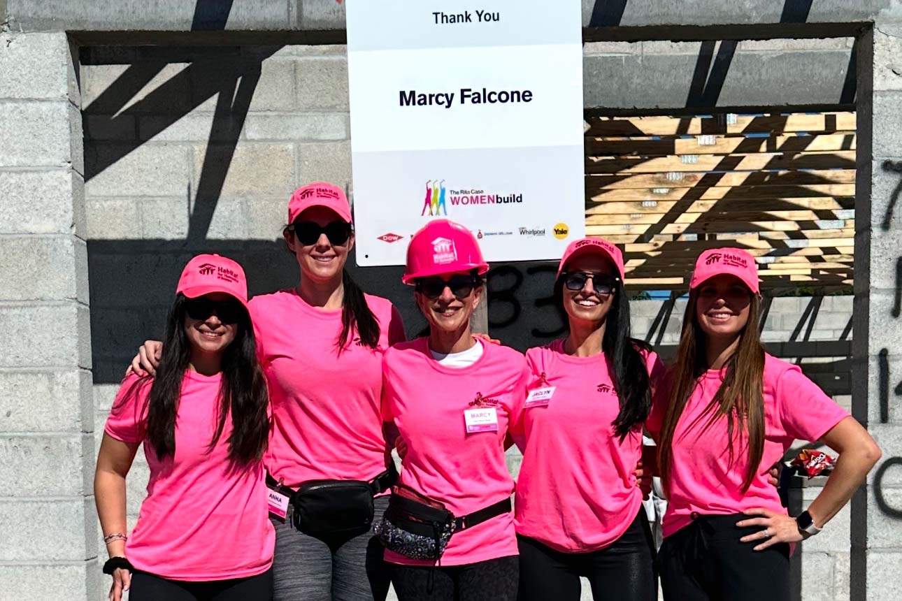 Marcy Falcone with her daughters-in-law, Anna, Ashley, Jaclyn, and Lauren Munzo, participate in the largest Habitat for Humanity village build in the United States.