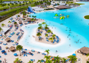 Aurora at Epperson Ranch Lagoon and beach with a crowd of people swimming, lounging, and paddleboarding