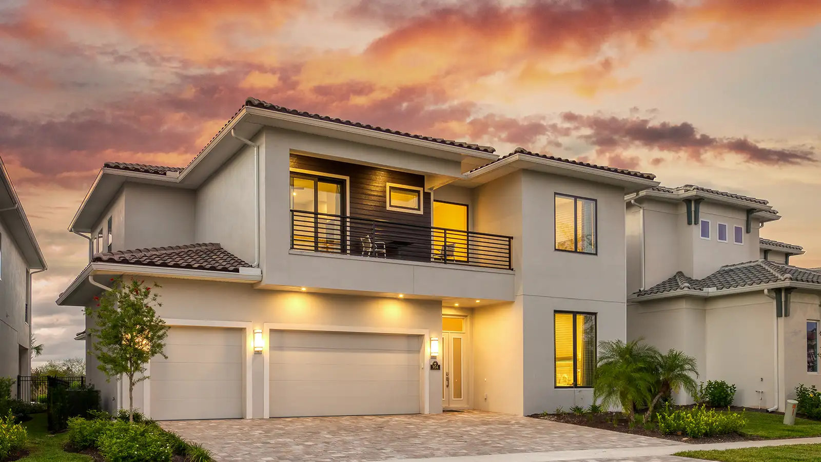 Luxury home with balcony and two-car driveway and garage